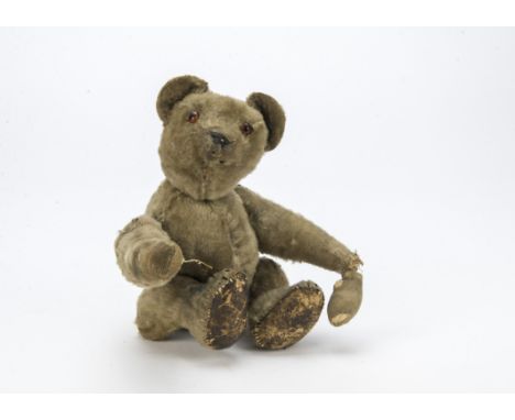 An unusual tumbling teddy bear, probably German, with blonde mohair, orange and black glass eyes, black stitched nose and rem