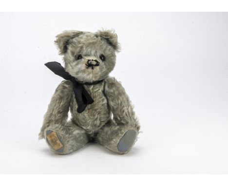 Elvis, a post-war Chad Valley blue mohair teddy bear, with orange and black glass eyes, remains of black stitched nose and mo