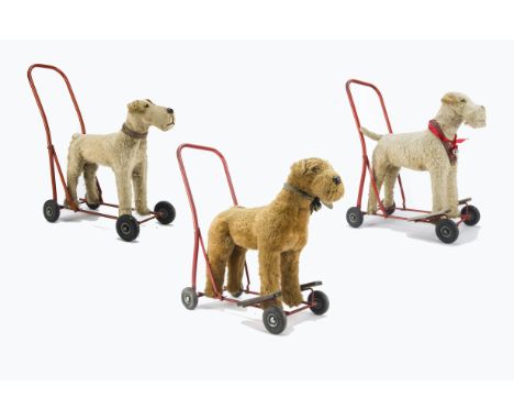 Three Lines Bros. Pedigree Airedale Terriers on wheels 1950s, two blonde and one light brown plush, red tubular frame, black 