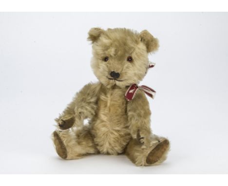 Sylvania, a small post-war Chiltern Hugmee teddy bear, with blonde mohair, orange and black glass eyes, black stitched nose, 