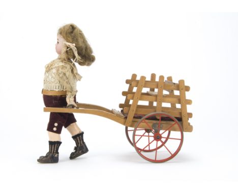 A Roullet & Decamps boy with cart automaton, the Simon & Halbig 1079 head with blue lashed eyes and brown mohair wig, a clock