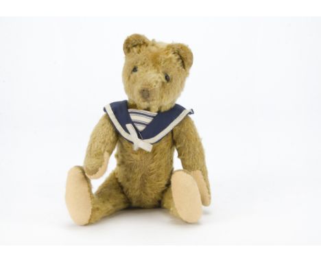 A German teddy bear, probably Cramer, with golden mohair, black boot button eyes, pronounced muzzle, delicately stitched brow