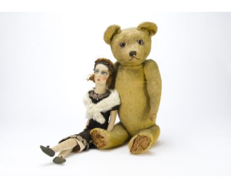 An early British teddy bear, 1920s, with golden mohair, clear and black oily glass eyes with remains of brown painted backs, 