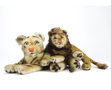 Steiff reclining Big Cats 1950s, a Tiger Cub with script button and yellow cloth tag- 19½in. (49.5cm.) wide and a smaller Leo