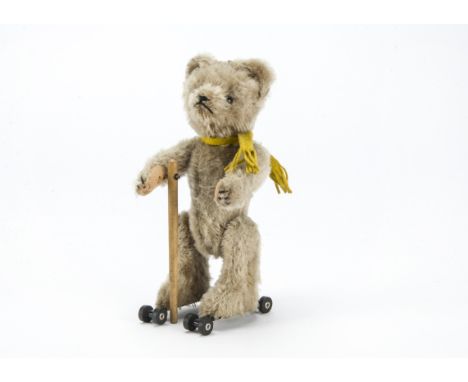 A Schuco Rolly teddy bear 1950s, with beige mohair, clear and black glass eyes with remains of brown painted backs, black sti