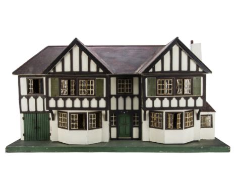 A large Tri-ang wooden dolls’ house No.93, mock Tudor design, half-timbered and cream painted, tinplate windows, green front 