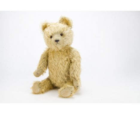 A German teddy bear 1930s, with golden mohair, replace orange and black glass eyes, pronounced clipped muzzle, black stitched