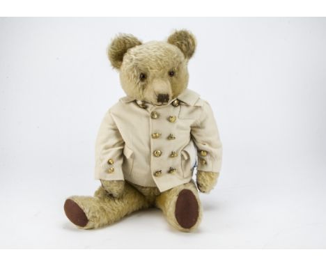 A 1930s Merrythought teddy bear, with light golden mohair, orange and black glass eyes, pronounced clipped muzzle, black stit