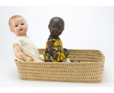 An Armand Marseille 518 composition black baby, with brown sleeping eyes, composition body with bent arms and straight legs a