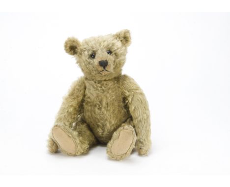 A fine Steiff centre seam teddy bear, circa 1910, with blonde mohair, black boot button eyes, pronounced clipped muzzle, blac