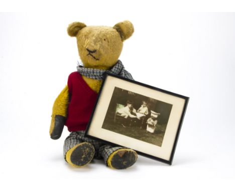 A 1930s teddy bear with provenance, with golden mohair, remains of black stitched nose and mouth, swivel head, jointed limbs 