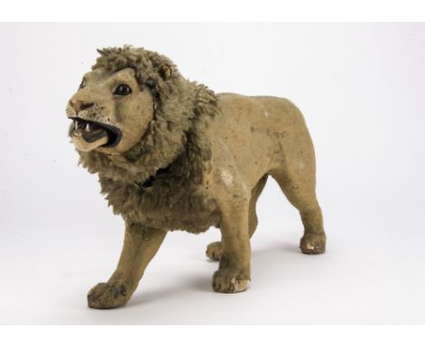 A German clockwork nodding lion automaton, felt covered carton with green and black glass eyes, sheepskin mane, keywind mecha