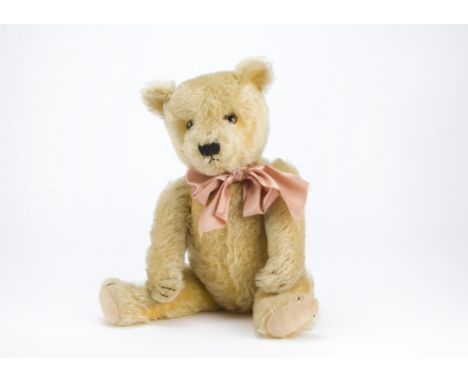 A Chiltern type teddy bear 1930s, with golden mohair, clear and black glass eyes with brown painted backs, pronounced muzzle,