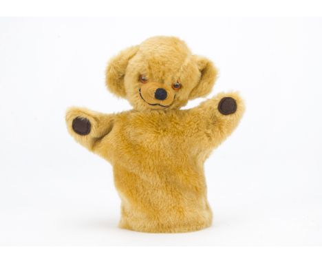 A Merrythought Cheeky teddy bear hand puppet, with golden mohair, orange and black plastic eyes and Harrods label - 9in. (23c