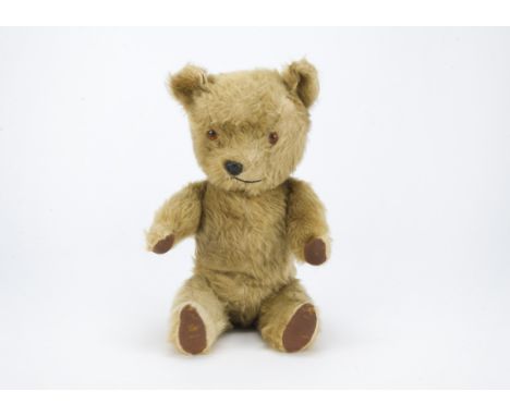 A post-war Chiltern Hugmee teddy bear, with blonde mohair/mix plush, orange and black plastic eyes, black plastic nose, swive