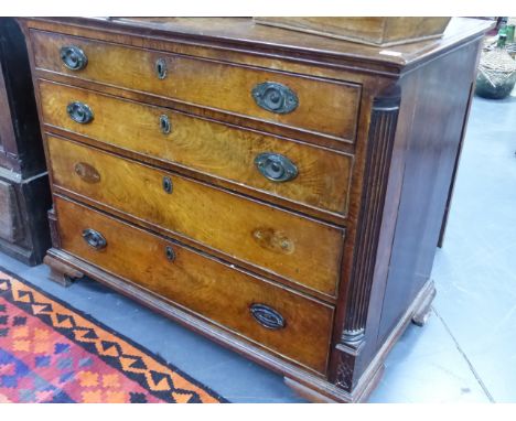 A GEORGIAN MAHOGANY BATCHELOR'S CHEST OF FOUR DRAWERS THE UPPER DRAWER WITH VARIOUS COMPARTMENTS, STANDING ON SHAPED OGEE BRA