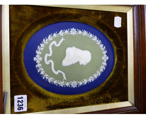A WEDGWOOD THREE COLOUR OVAL JASPERWARE PORTRAIT PLAQUE OF JOHN WESLEY WITH IMPRESSED MARKS AND SIGNED T.LOVATT.   21 x 18cms