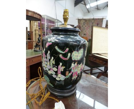 A CHINESE FAMILLE MOIRE BALUSTER FORM VASE WITH FIGURAL DECORATION MOUNTED AS A LAMP ON A CARVED BASE.   OVERALL H.43cms.