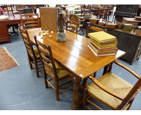 A GOOD QUALITY 18th..C.STYLE OAK REFECTORY TABLE TOGETHER WITH A SET OF SIX RUSH SEAT LADDER BACK CHAIRS.