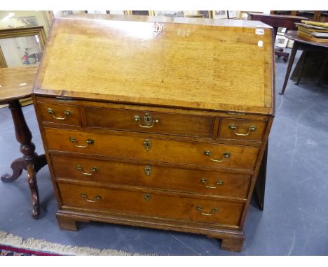 A LATE 18th.C.OAK BUREAU WITH THREE SHORT AND THREE LONG DRAWERS ON BRACKET FEET.   W.92 x H.101cms.