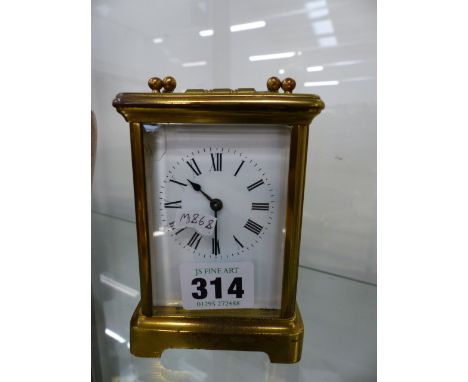 AN EARLY 20th.C.BRASS CASED CARRIAGE CLOCK WITH WHITE ENAMEL DIAL.