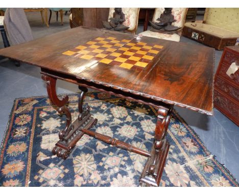 A WM.IV.ROSEWOOD GAMES TABLE WITH CHESS BOARD INLAID FOLD OVER TOP AND FRIEZE DRAWER.   