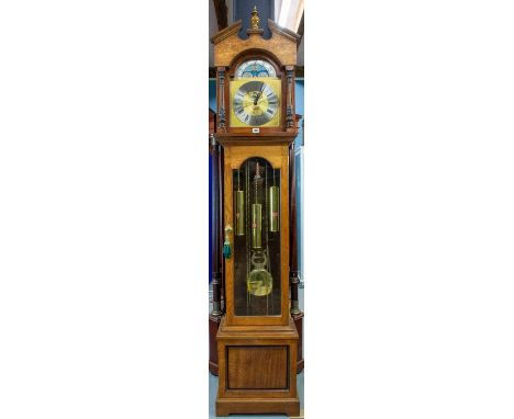 A 20th century oak long cased clock the weight driven three train movement by kieninger striking and chiming on rods,(Whittin