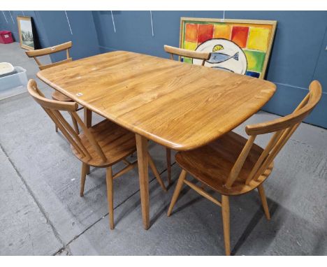 An Ercol oak flap top table, together with two pairs of chairs
