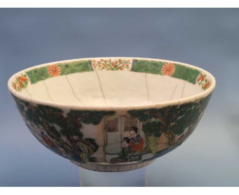An antique Chinese crackle glazed bowl with Famille vert decoration and incised seal mark to the base. 21 cm diameter.good ag