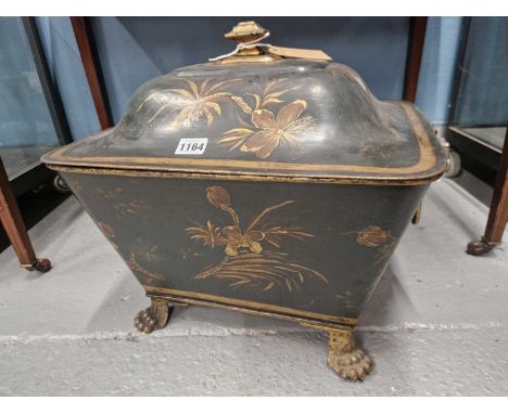A black tole coal bucket and cover with lion mask and ring hanles and on four paw feetSome wear to the paint work and rusting