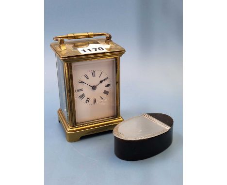 A French carriage clock striking on a coiled rod together with an oval sectioned faux tortoiseshell snuff box with a silvered