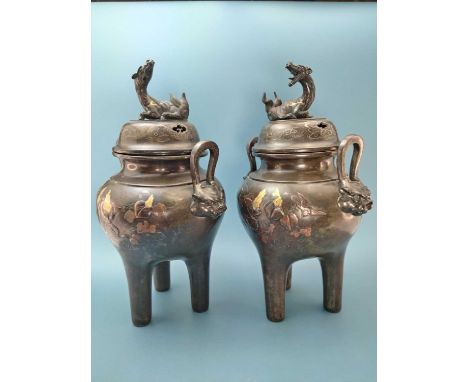 A pair of Japanese bronze incense burners liners and covers, the latter surmounted by qilin reclining above silver wire inlai