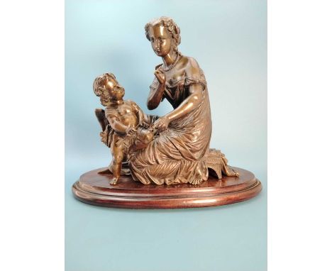 A 19th C. bronze group of a lady seated on a low stool contemplating Cupid holding and arrow, with a wood stand.   H 28cms