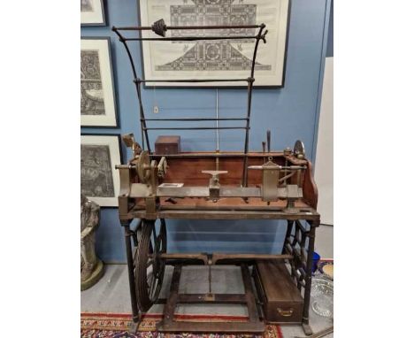 A rare mid-19th century brass and iron ornamental turning lathe signed C. Rich, 44 Denmark Street London. Mounted on a decora