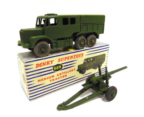 TWO DINKY DIECAST MODEL MILITARY VEHICLES comprising a No.689, Medium Artillery Tractor, olive green with matching grooved hu