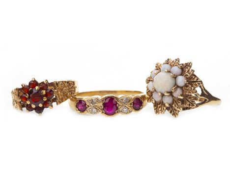 THREE GEM SET RINGS, comprising an opal cluster ring in nine carat gold, size M, 4.1g; a red gem set cluster ring in nine car