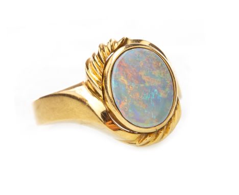 OPAL RING, set with an oval section of opal 10x8mm, in a twist setting with ribbed detail, unmarked, size M 1/2, 6.9g