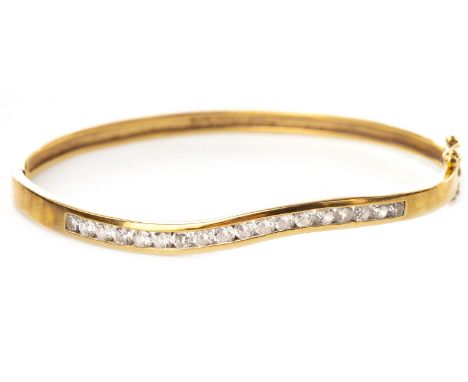 WHITE GEM SET BANGLE, the waved top section with channel set white gems, 61mm to outer edge, unmarked, 10.3g
