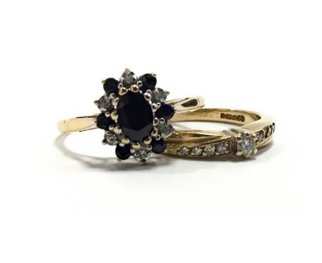 TWO NINE CARAT GOLD RINGS, one set with a central oval blue gem 6mm long within a diamond and blue gem set halo, size N, 2g; 