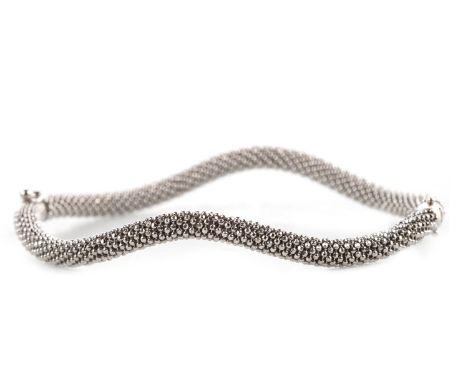 ORNATE BANGLE, formed by rows of spheres, rigid and of waved form, 68mm to outer edge, marked 750, 14.1g