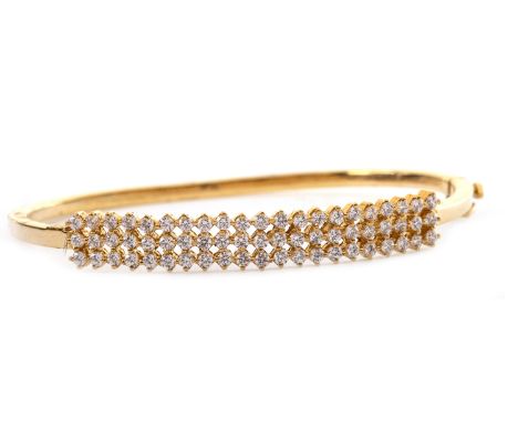 WHITE GEM SET BANGLE, of oval form, set with three rows of round white faceted gems, 61mm to outer edge, marked 916, 12.5g