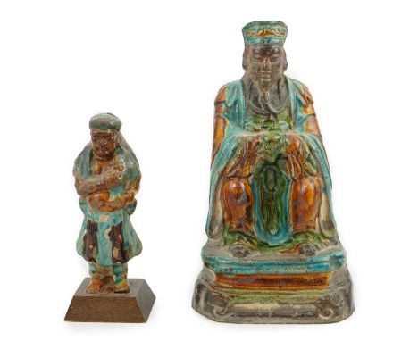 Two Chinese sancai glazed figures of a seated dignitary and a standing attendant, Ming dynasty, the largest 27cm highProvenan