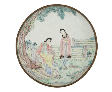 A Chinese Guangzhou enamel saucer dish, 19th century, delicately painted in pastel tones with two ladies in a rockwork garden