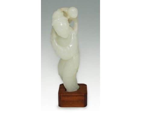 A Chinese white jade figure of a monkey trainer, 18th century, the standing figure with a monkey on his back, the stone of go