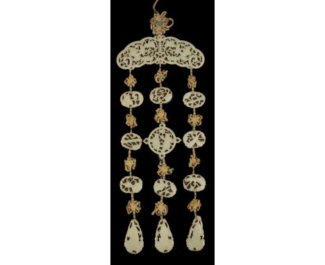 A Chinese pale celadon jade ‘Eight Daoist emblems’ multi-plaque wedding pendant, 19th century, the reticulated upper arched p