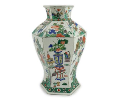 A large Chinese famille verte hexagonal baluster vase, Kangxi period, the panelled body painted with Antiques and birds amid 
