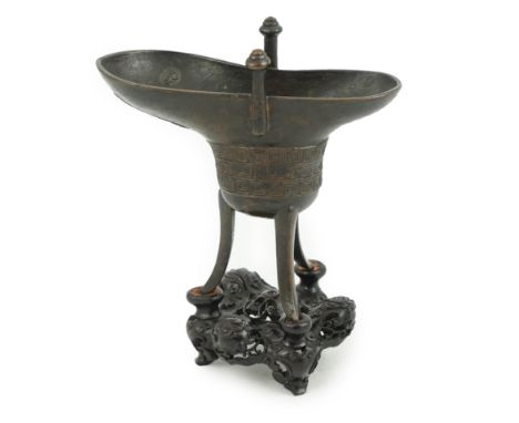 A good Chinese archaistic bronze tripod wine cup, jue, dated Qianlong 3rd year, corresponding to 1738, crisply cast under the