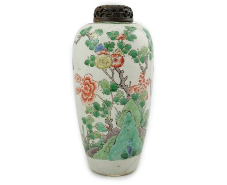 A Chinese famille verte jar, Kangxi period, of elongated ovoid form, painted with flowering shrubs and rockwork, underglaze b