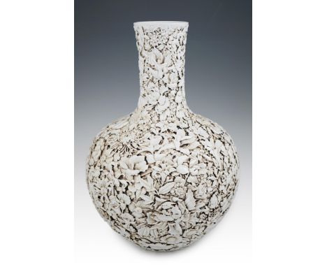 A large Chinese carved porcelain ‘thousand flower’ bottle vase, 20th century, intricately carved and applied with white glaze