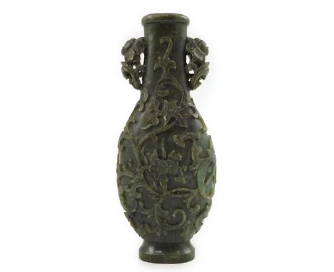 A Chinese spinach green jade arrow vase, hu, 18th/19th century, of flattened bottle shape, crisply carved in high relief with